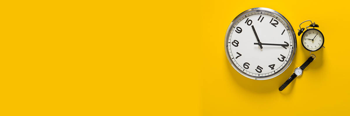 pocketwatch and wrist watch on yellow background